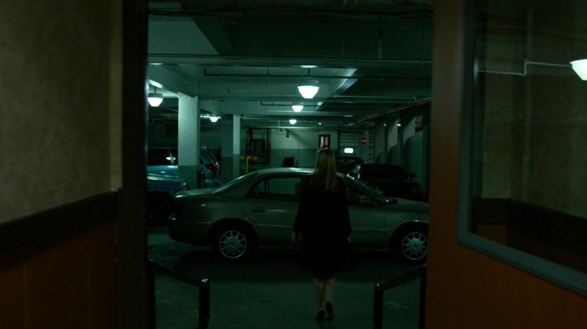 Karen walking into parking garage at the Hotel Travel Inn.