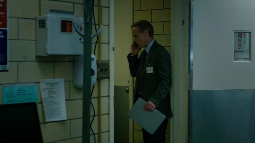 A Hospital administrator on the phone in the Metro-General morgue.