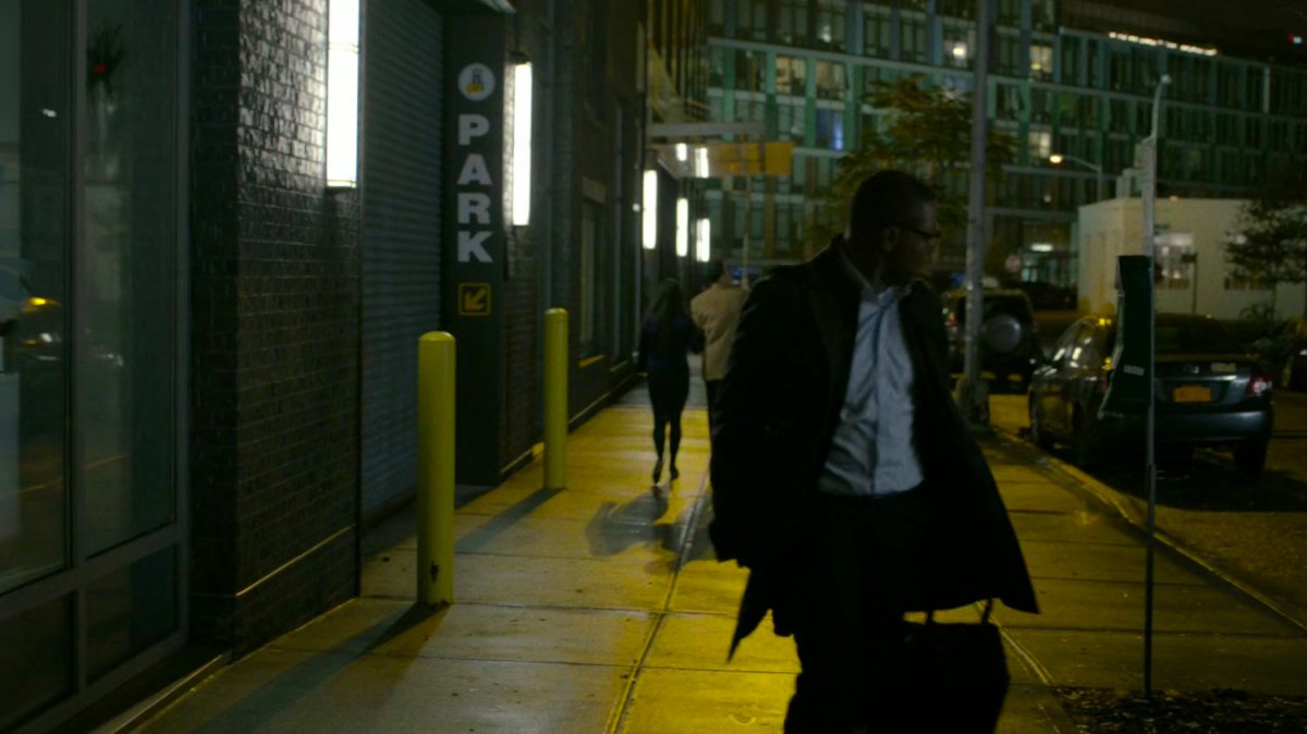 ADA Tower walks along a dark sidewalk.