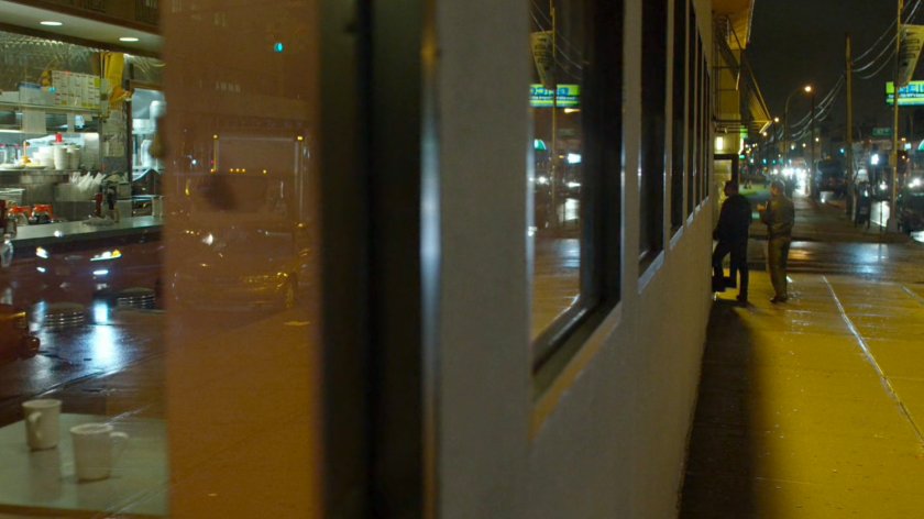 Two men enter an empty diner.