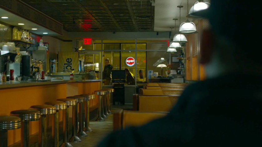 Two men enter an empty diner.