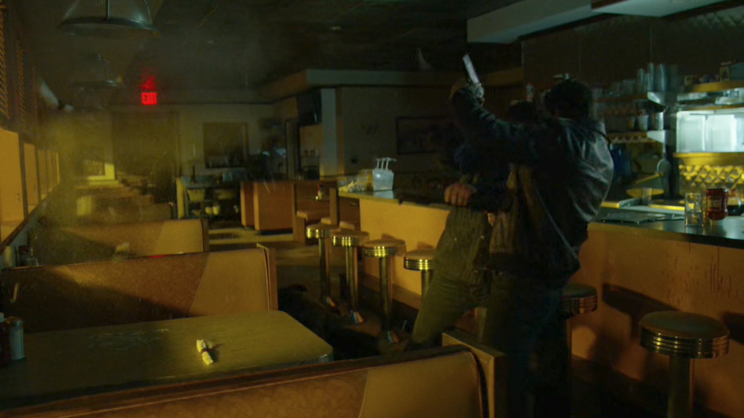 Frank fights a man in an empty diner.