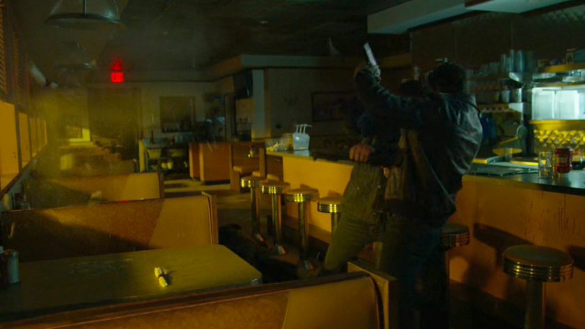 Frank fights a man in an empty diner.