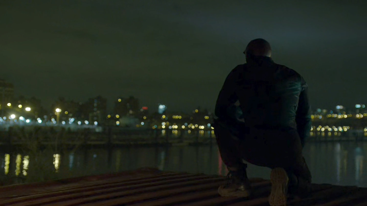Daredevil crouched on shipping container above Pier 81.