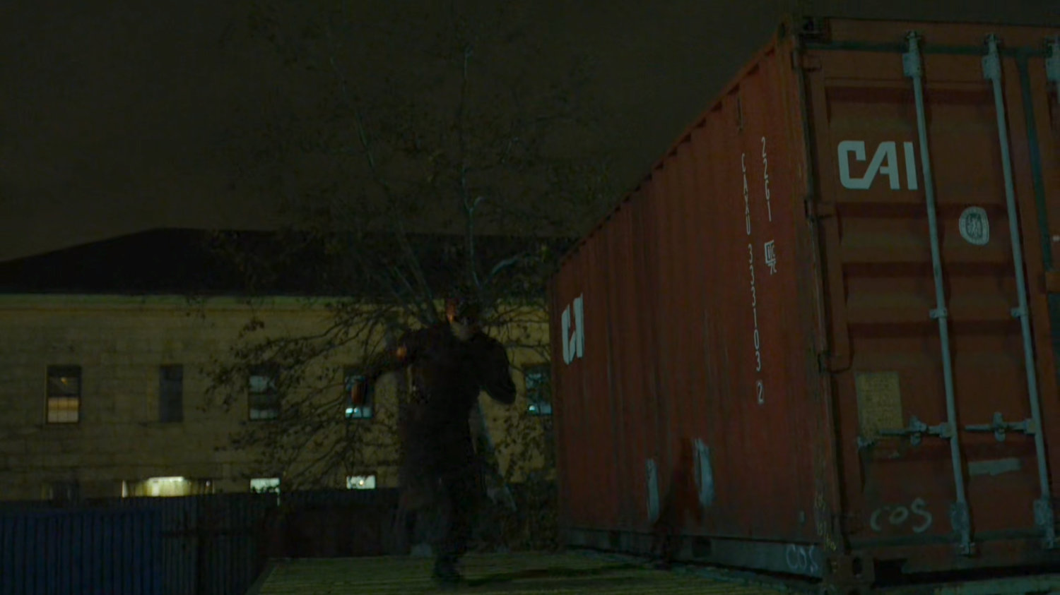 Daredevil running past shipping container on Pier 81.