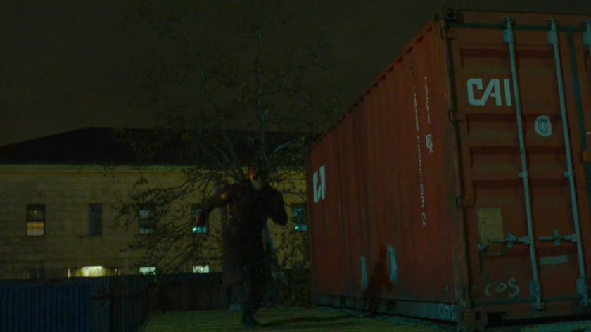 Daredevil running past shipping container on Pier 81.