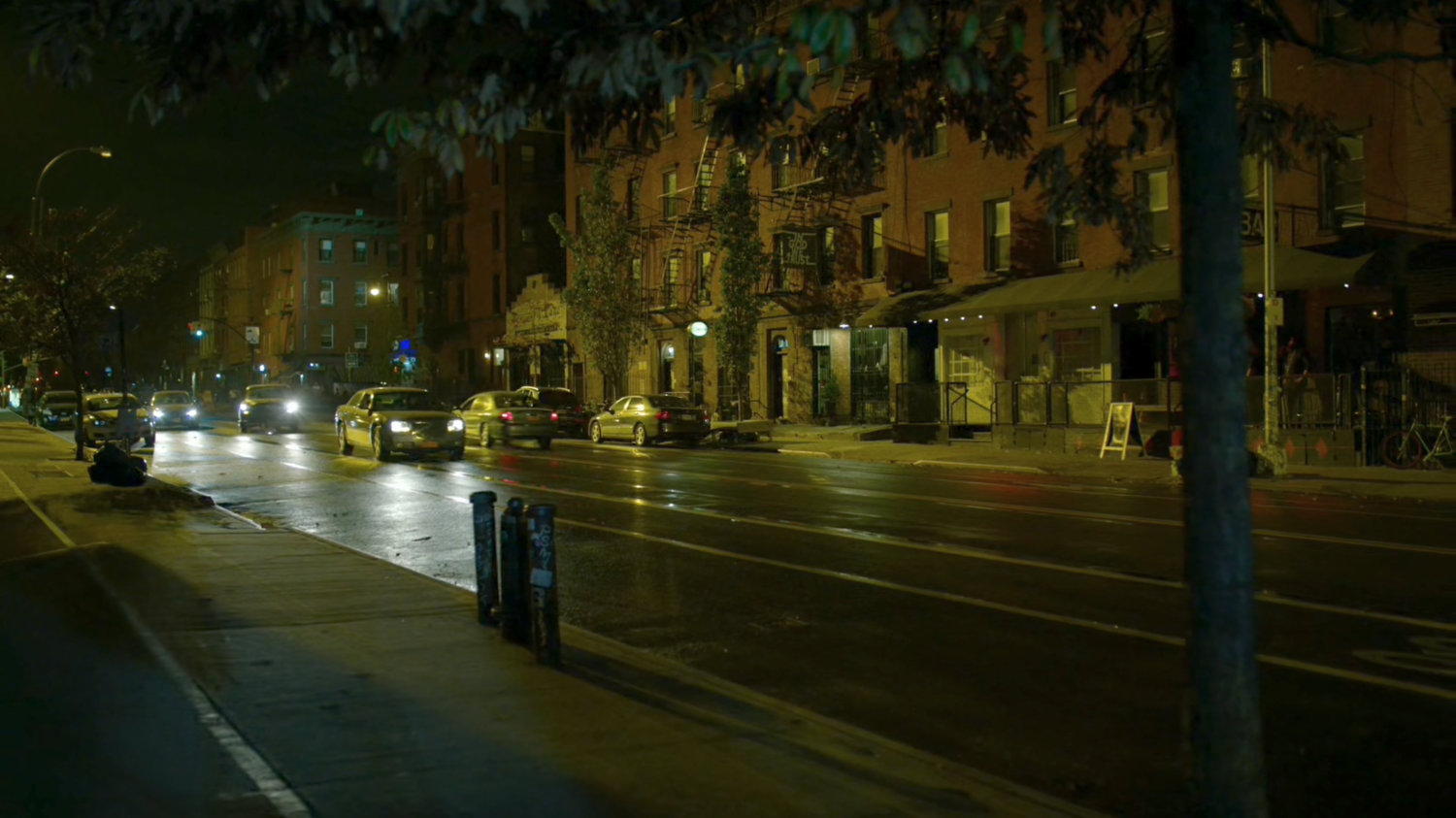 A car recklessly approaches Matt's apartment entrance.