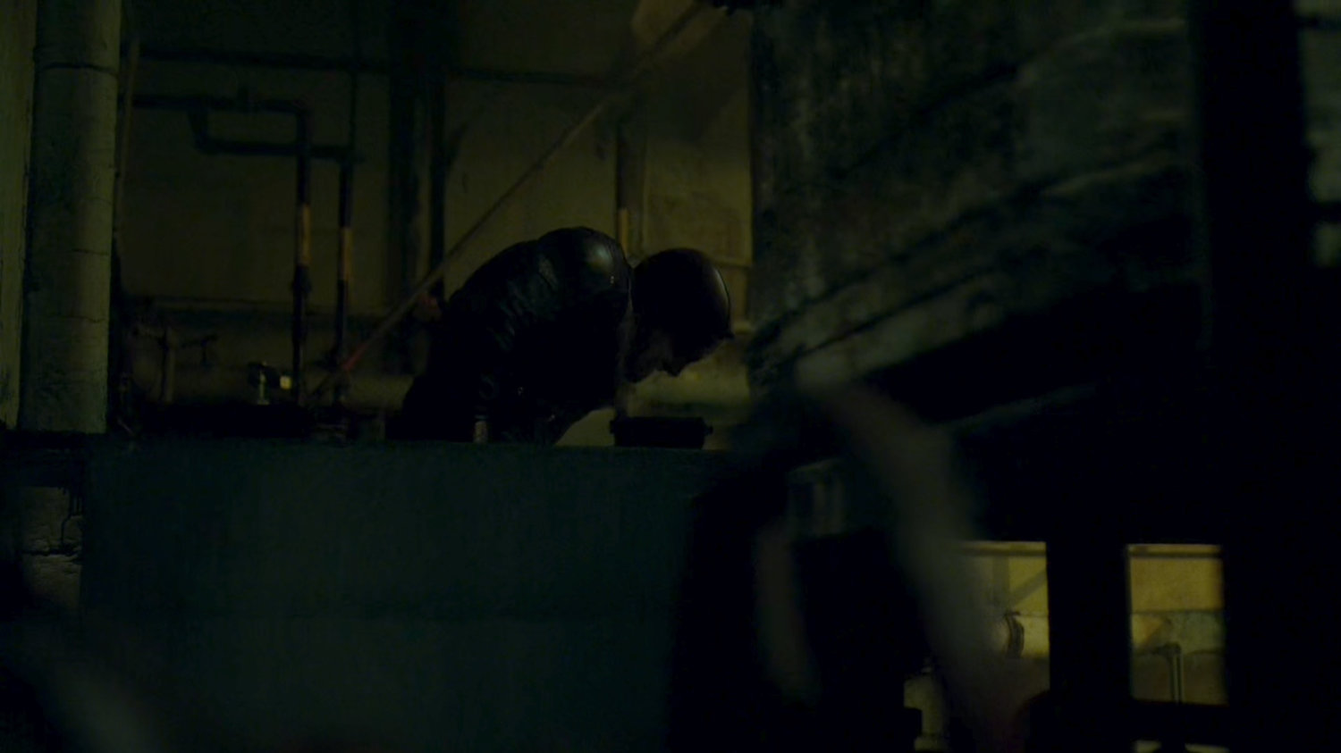 Daredevil climbs out hatch into abandoned steam plant.