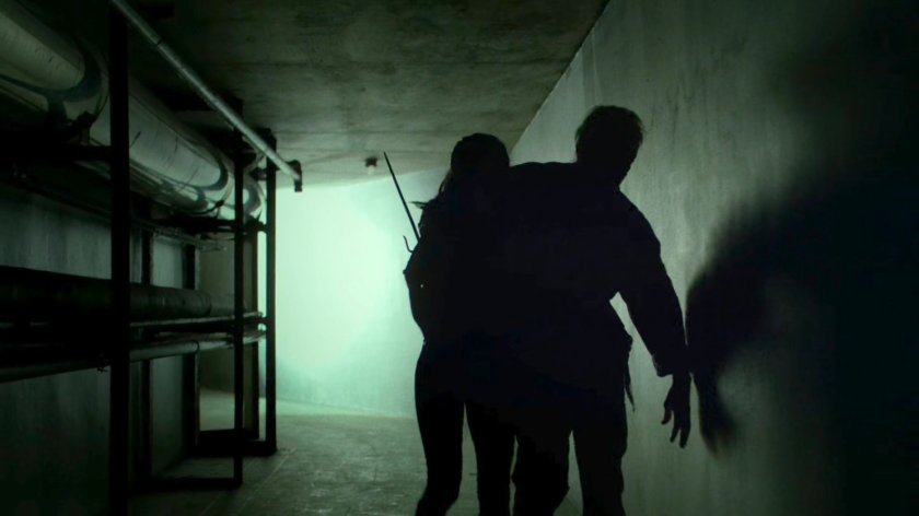 Elektra helping Stick through corridor of an abandoned steam plant.