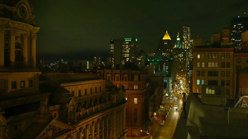 Elektra standing on the roof of Matt's apartment building, overlooking the city.