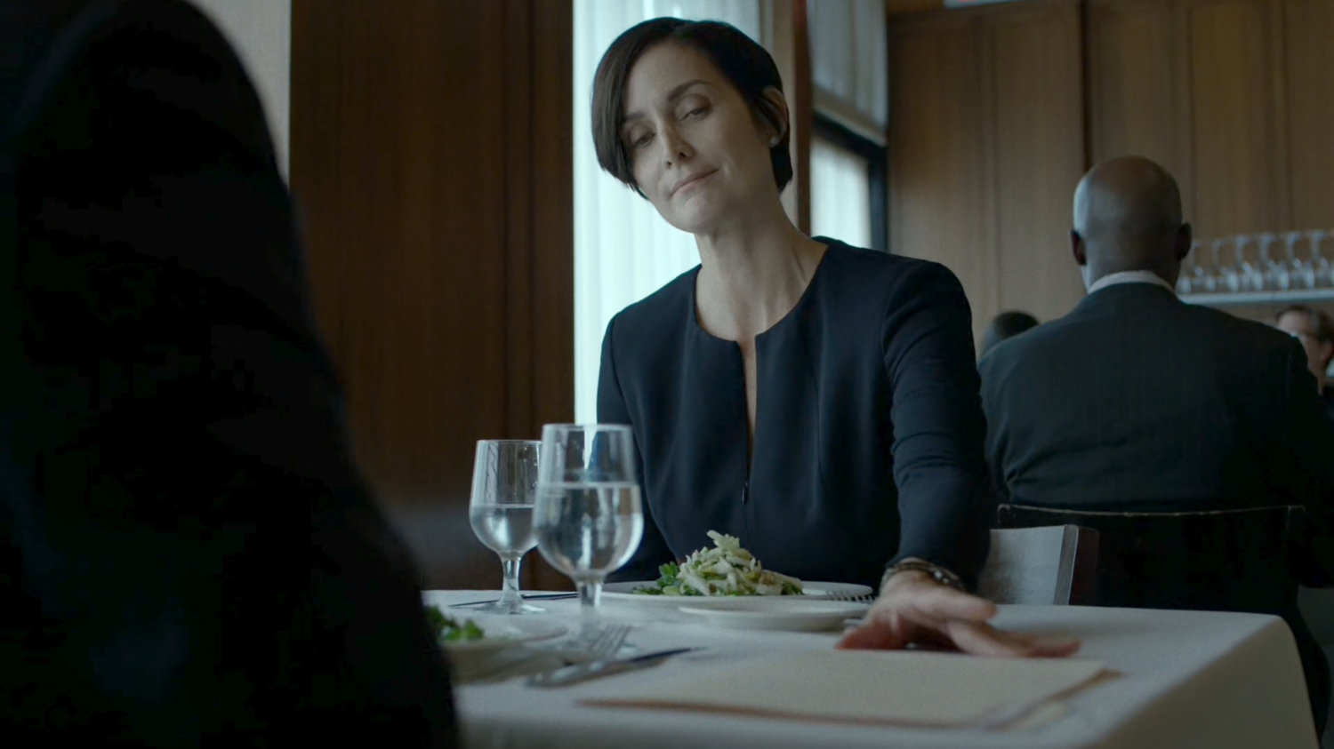 Jeri Hogarth sliding paperwork across table to Foggy in an upscale restaurant.