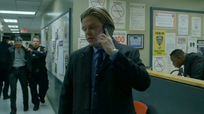 Foggy on the phone inside the 15th Precinct.