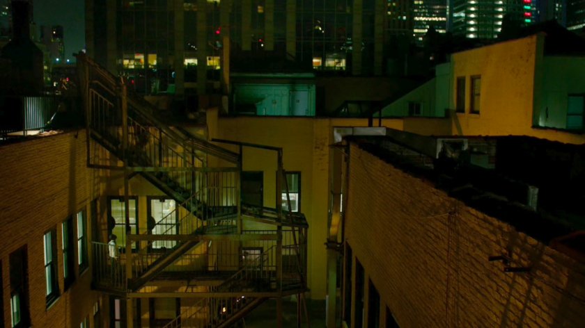 Daredevil sprints up the fire escape outside the 15th Precinct.
