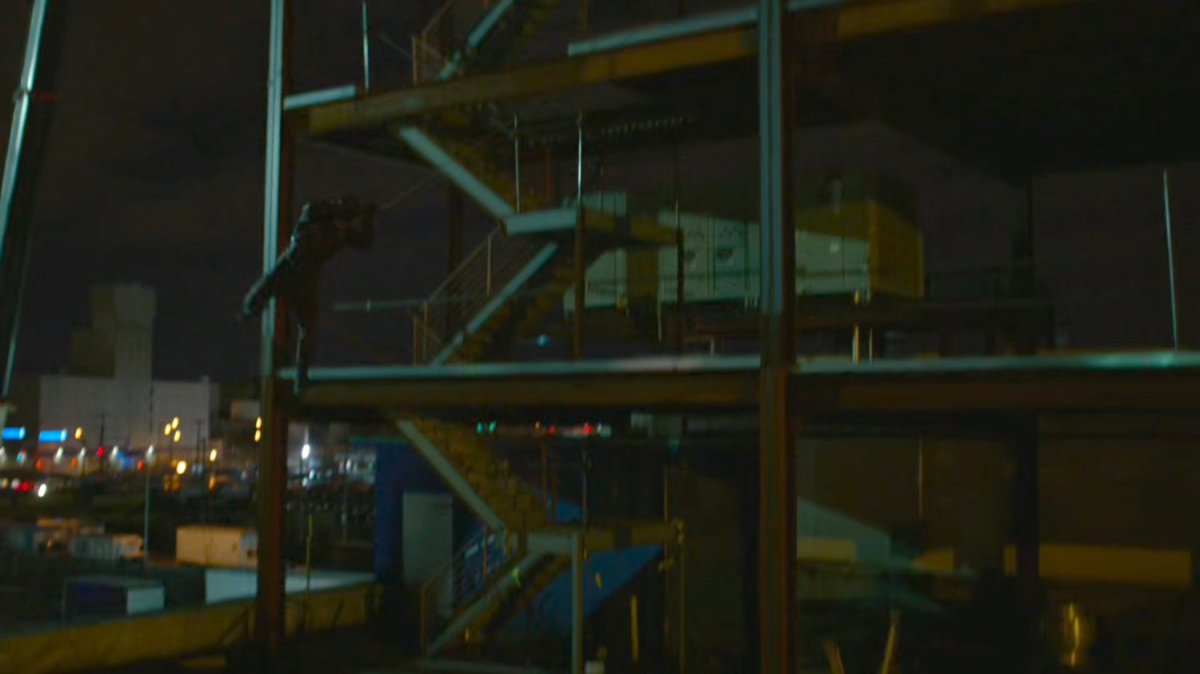 Daredevil swings from the girders of a construction site.