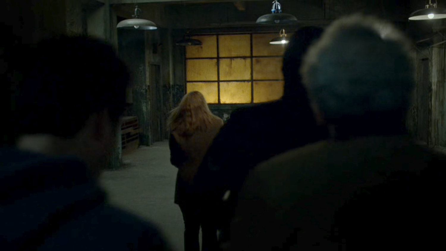 Hand soldiers force hostages into abandoned warehouse.