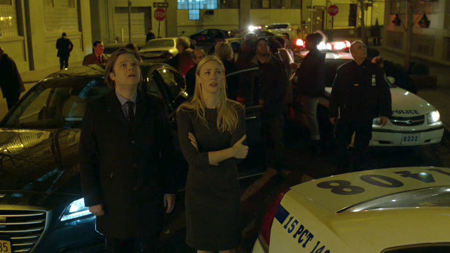 Karen, Foggy, the hostages, and police in an alley outside an abandoned warehouse.