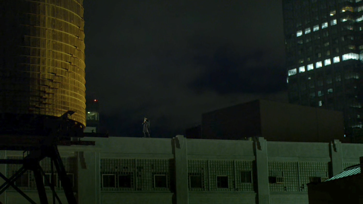 Frank Castle standing on top of a warehouse rooftop.