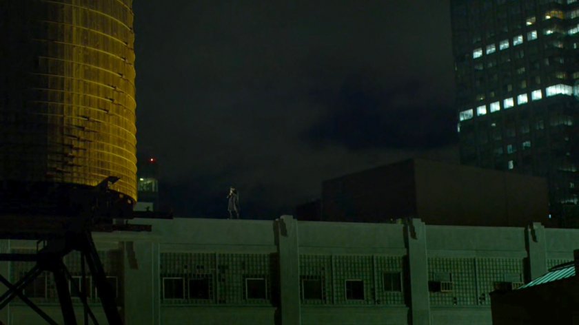 Frank Castle standing on top of a warehouse rooftop.