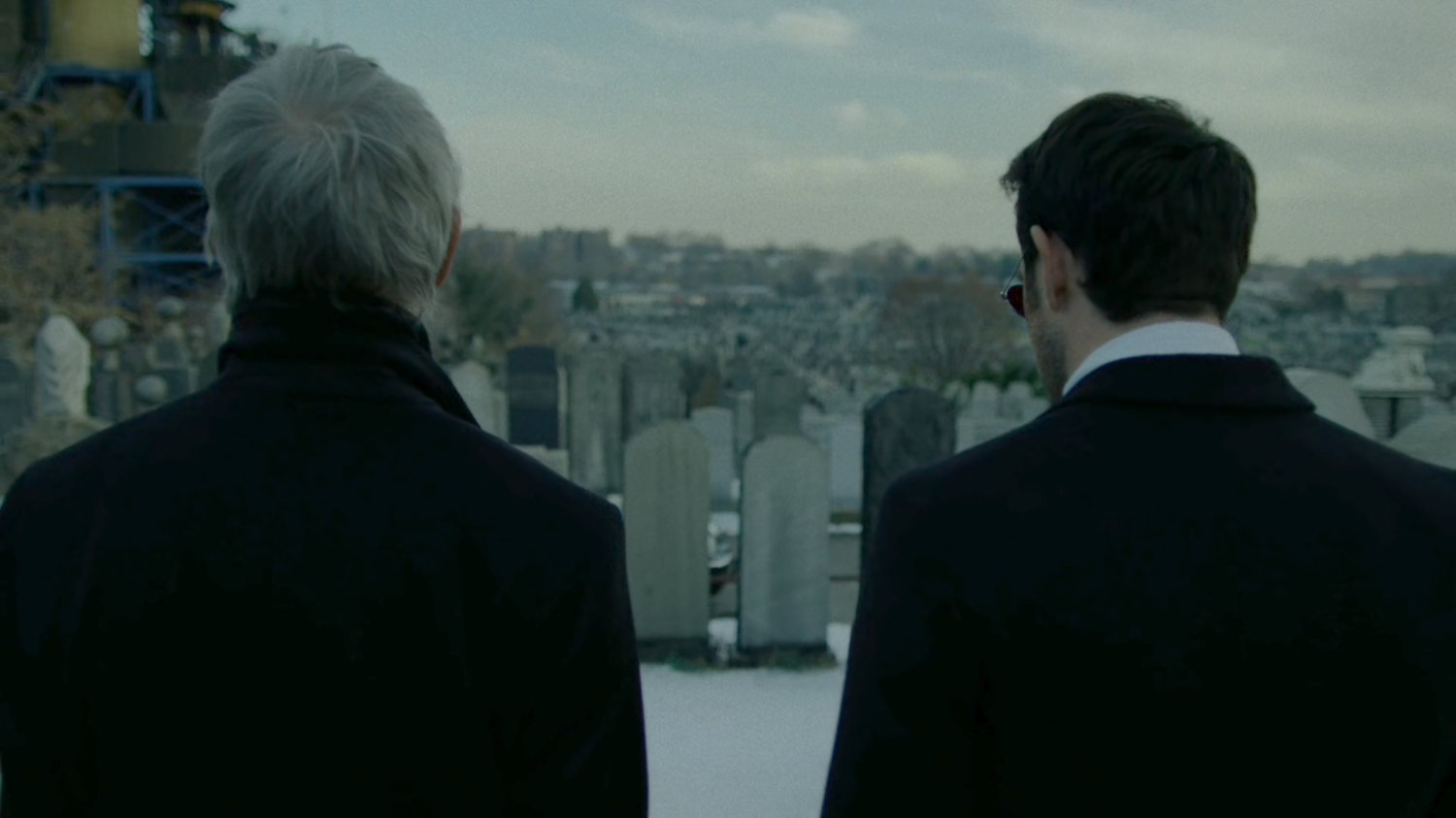 Stick and Matt at a snowy cemetery.