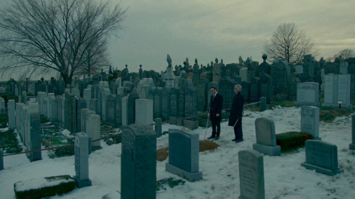 Stick and Matt at a snowy cemetery.