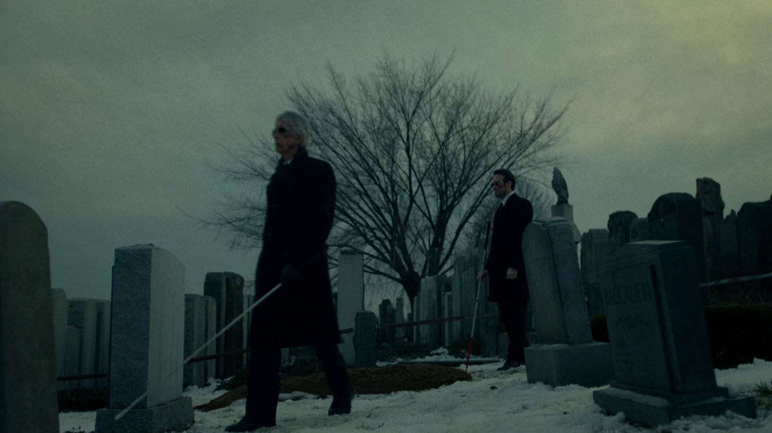 Stick and Matt at a snowy cemetery.