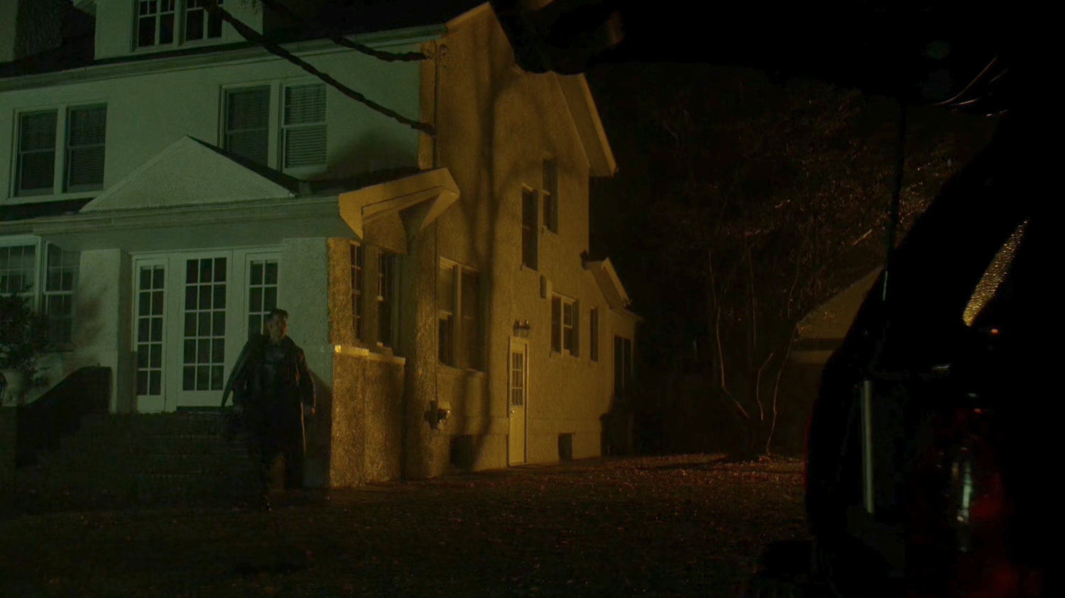 Frank Castle walking away from his house.