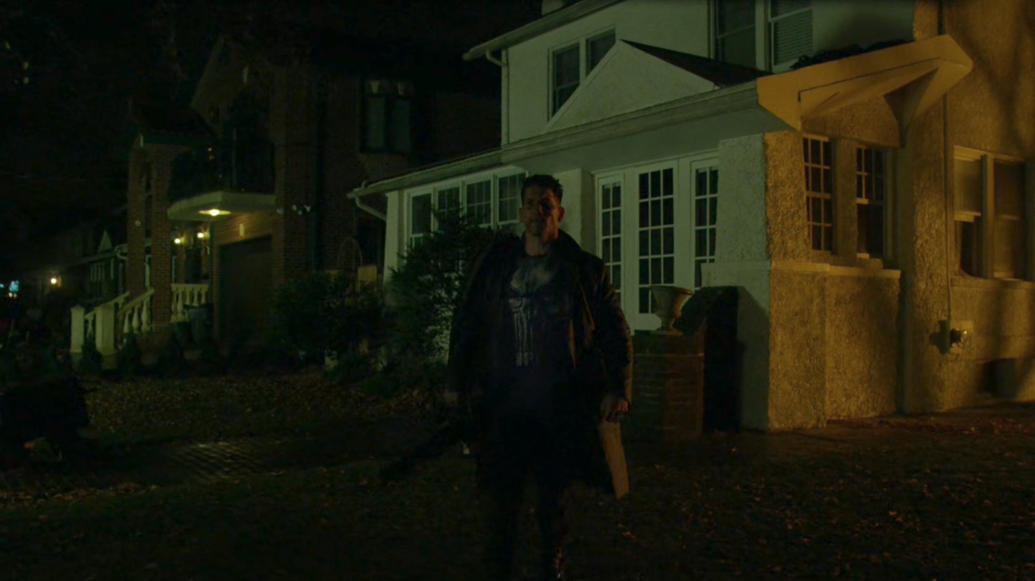 Frank Castle walking away from his house.