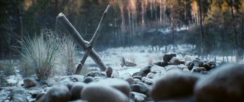 Wooden cross on snowy North Dakota ground.