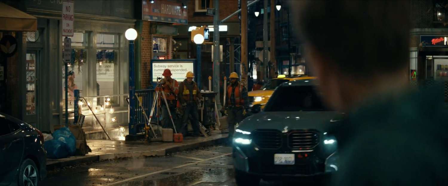Wade looking at construction workers near subway.