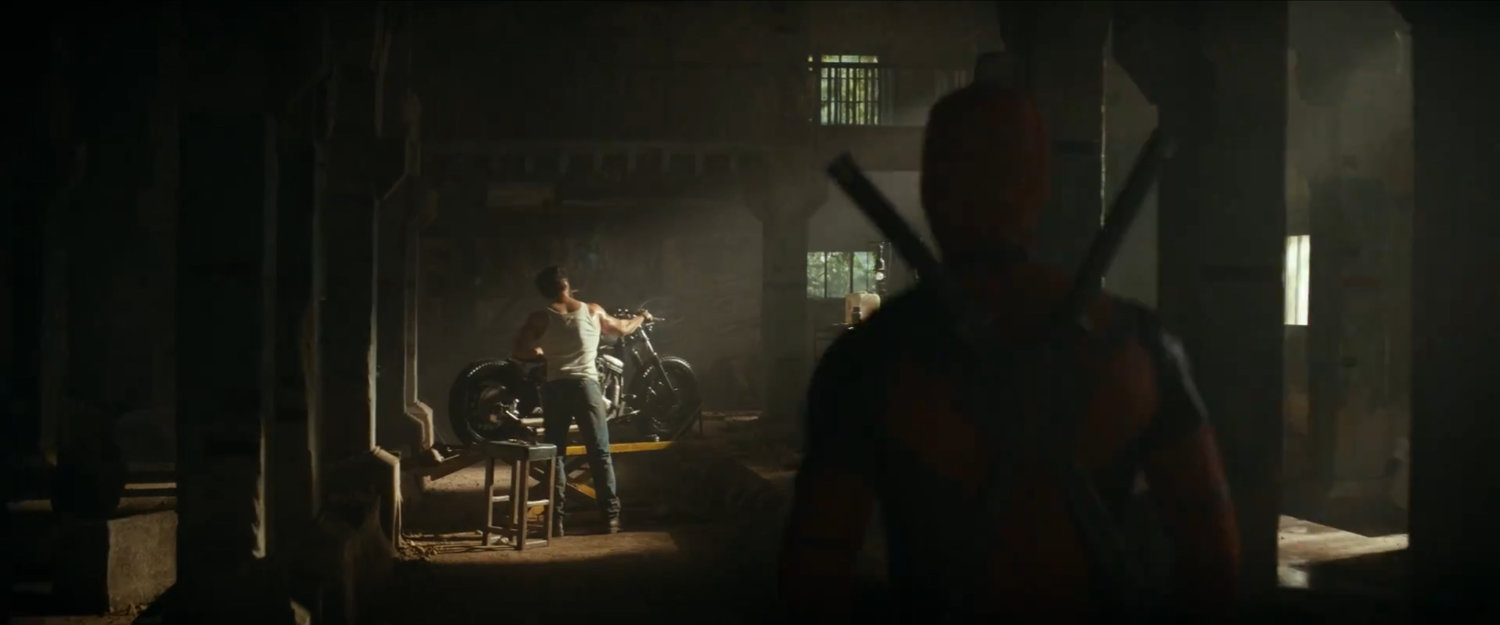 Deadpool looking at Calverine in dirty warehouse.