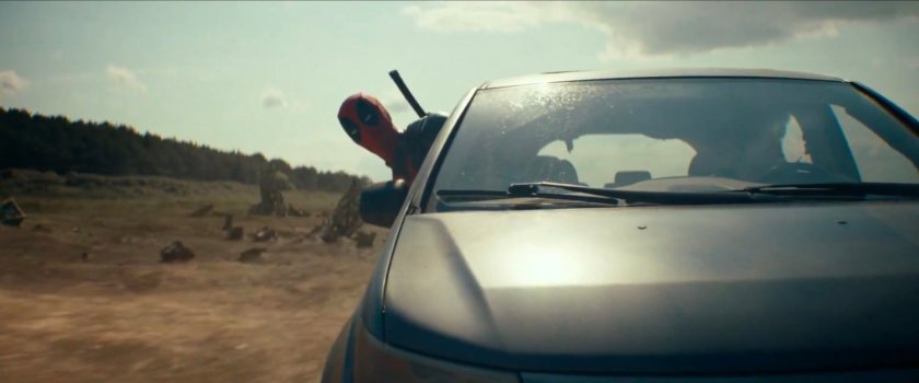 Deadpool leaning out of minivan window in The Void.