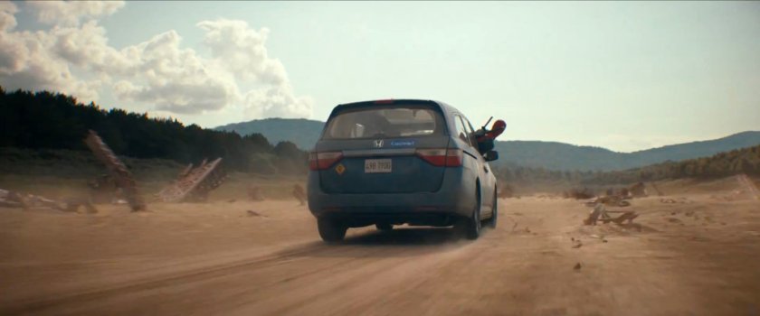 Deadpool leaning out of minivan window in The Void.