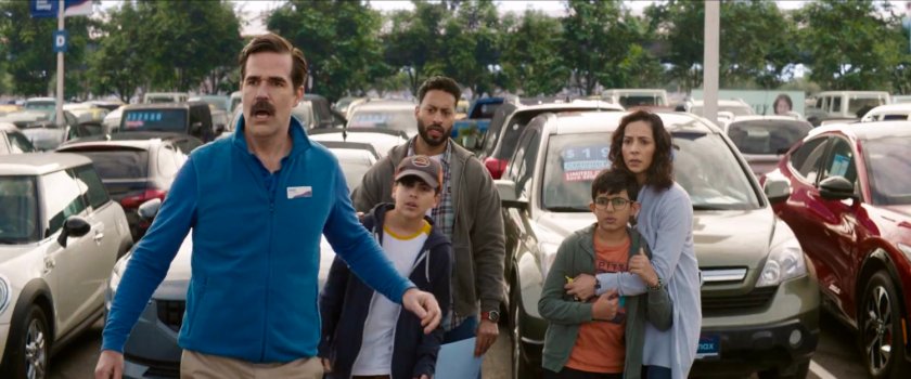 Peter and a family on the lot of a Drivemax used car lot.