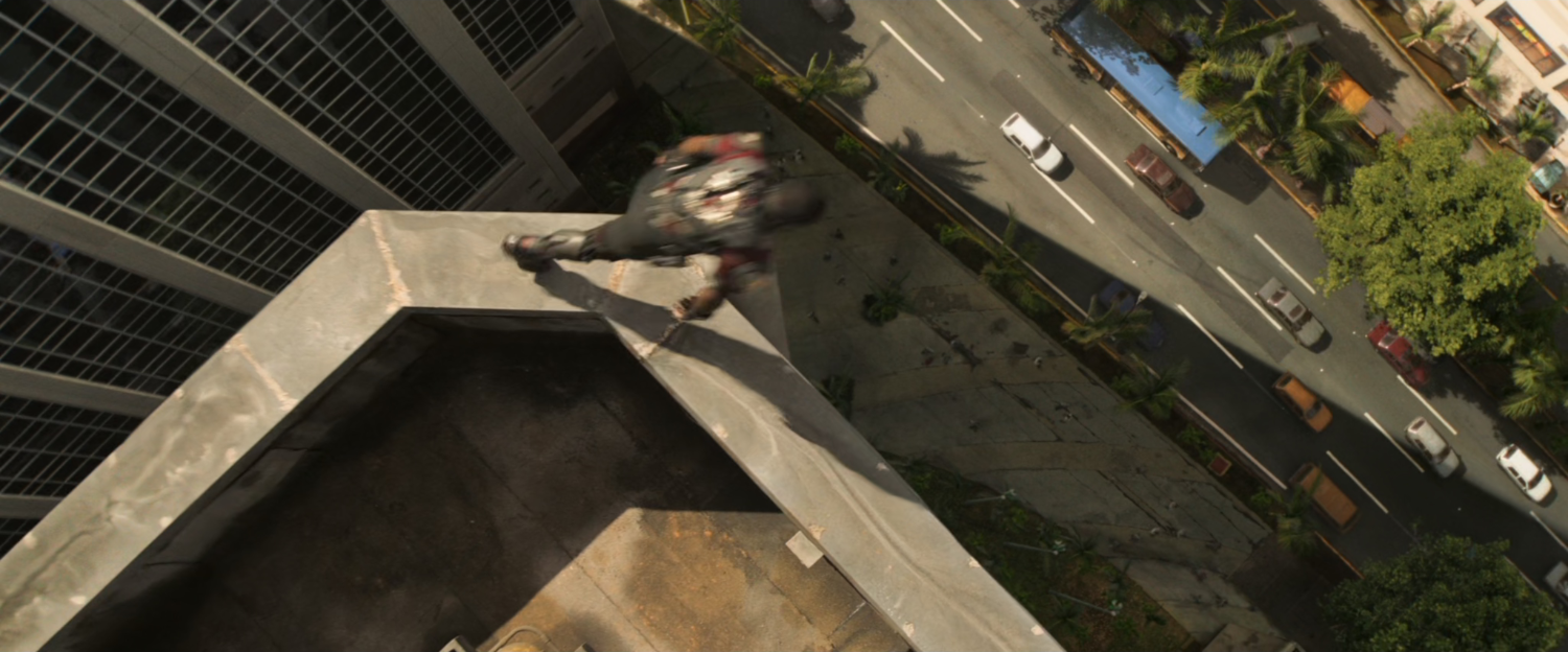 Sam leaping off a rooftop in Lagos.