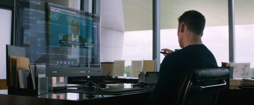 Steve watches news report in his office in Avengers HQ.