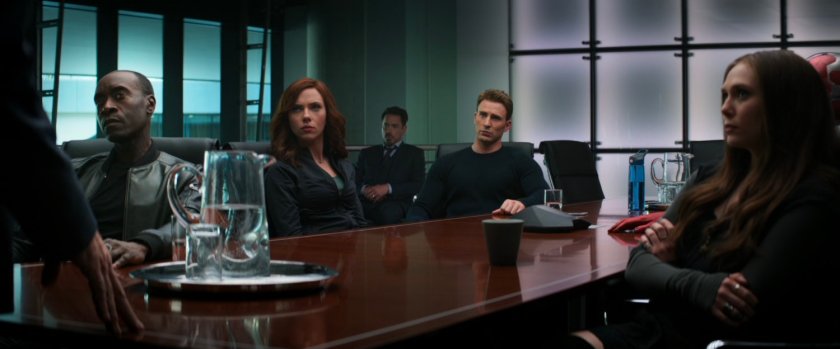 The Avengers listen to Secretary Ross in the conference room of their HQ.