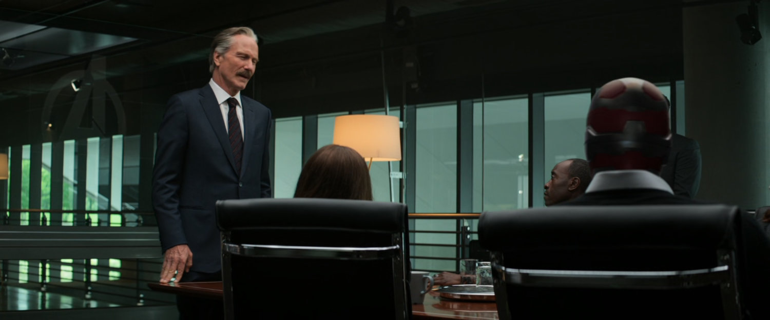 Secretary Ross speaks to the Avengers in the conference room of their HQ.