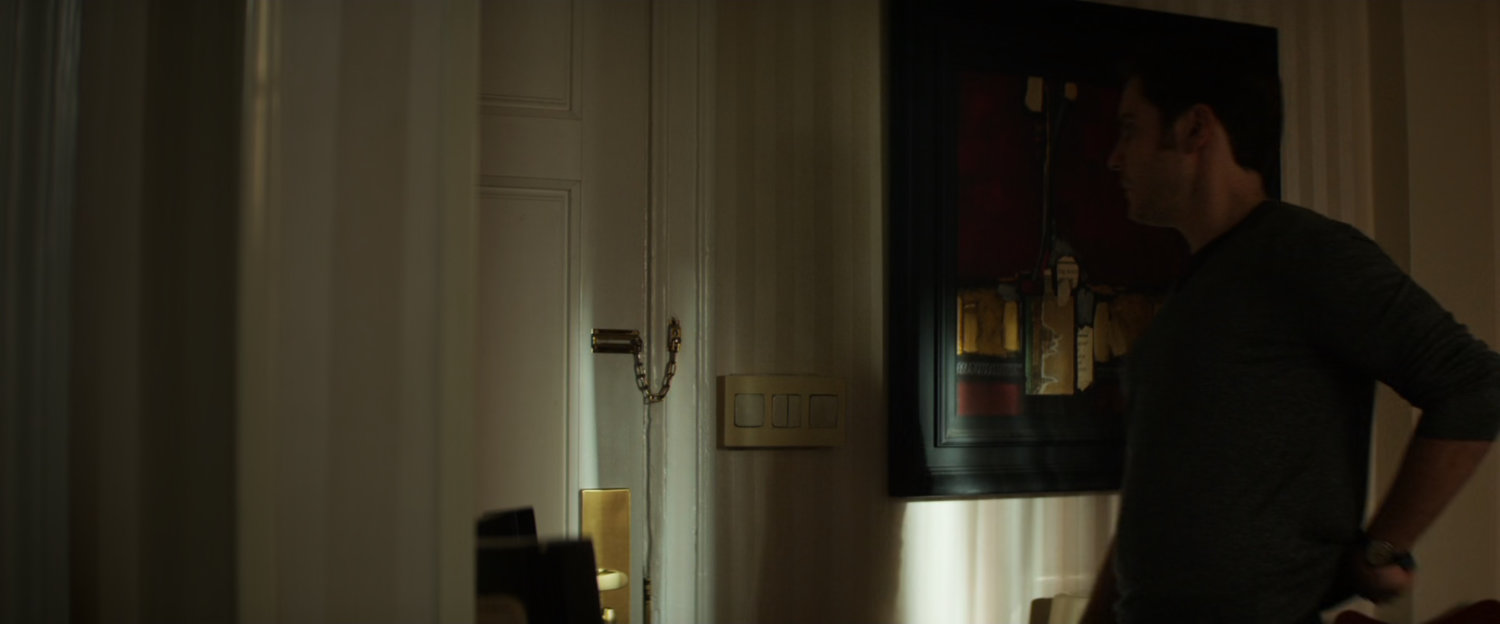 Zemo answers a door at a Berlin hotel room.