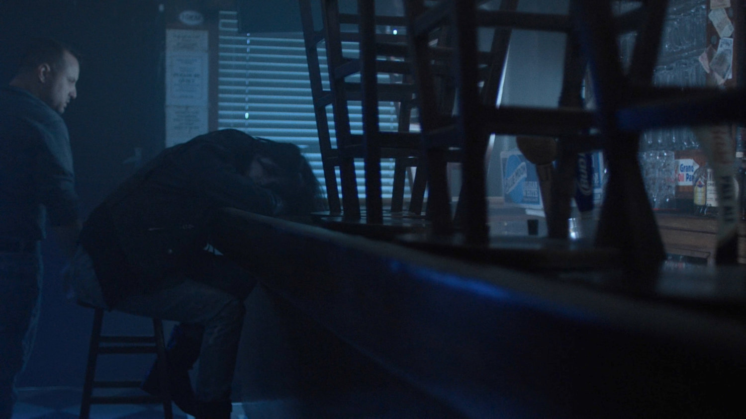 Jessica Jones in a dark bar.