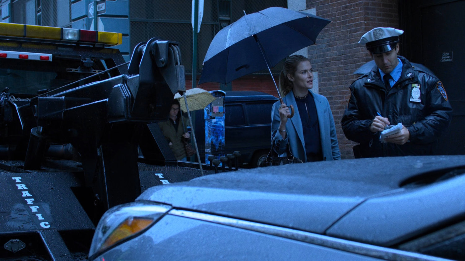 Trish Walker talks to an officer towing her car.