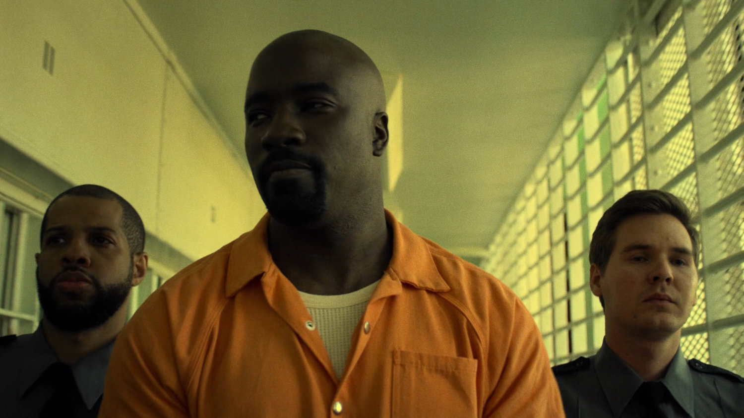 Luke Cage escorted along hallway at Seagate prison.