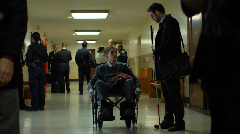 Matt speaks with Aaron in a court house hallway.