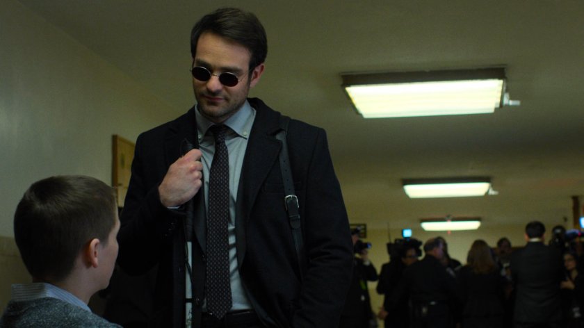 Matt speaks with Aaron in a court house hallway.