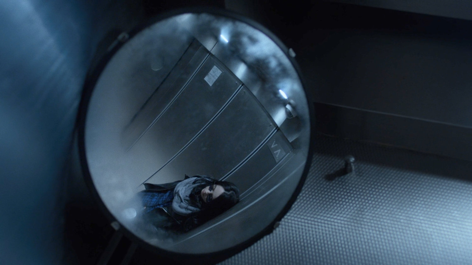 Reflection of Jessica Jones in the elevator of her building.