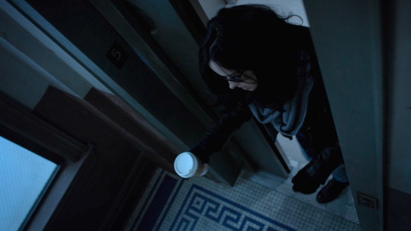 Jessica Jones exits the elevator in her building.