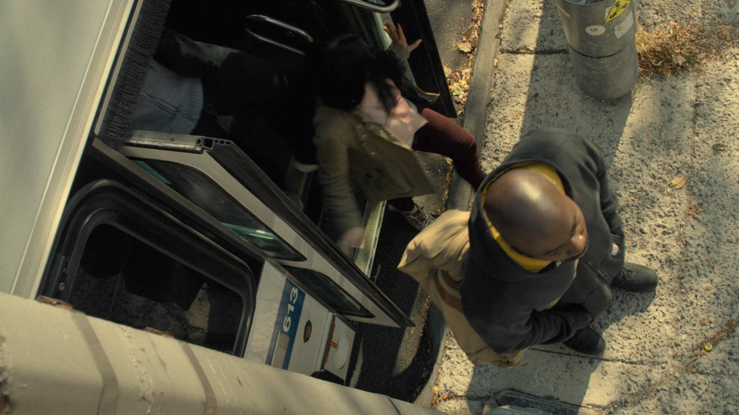 Luke Cage stepping off city bus in Harlem.