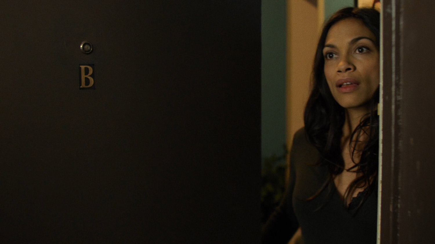Claire answering her apartment door.