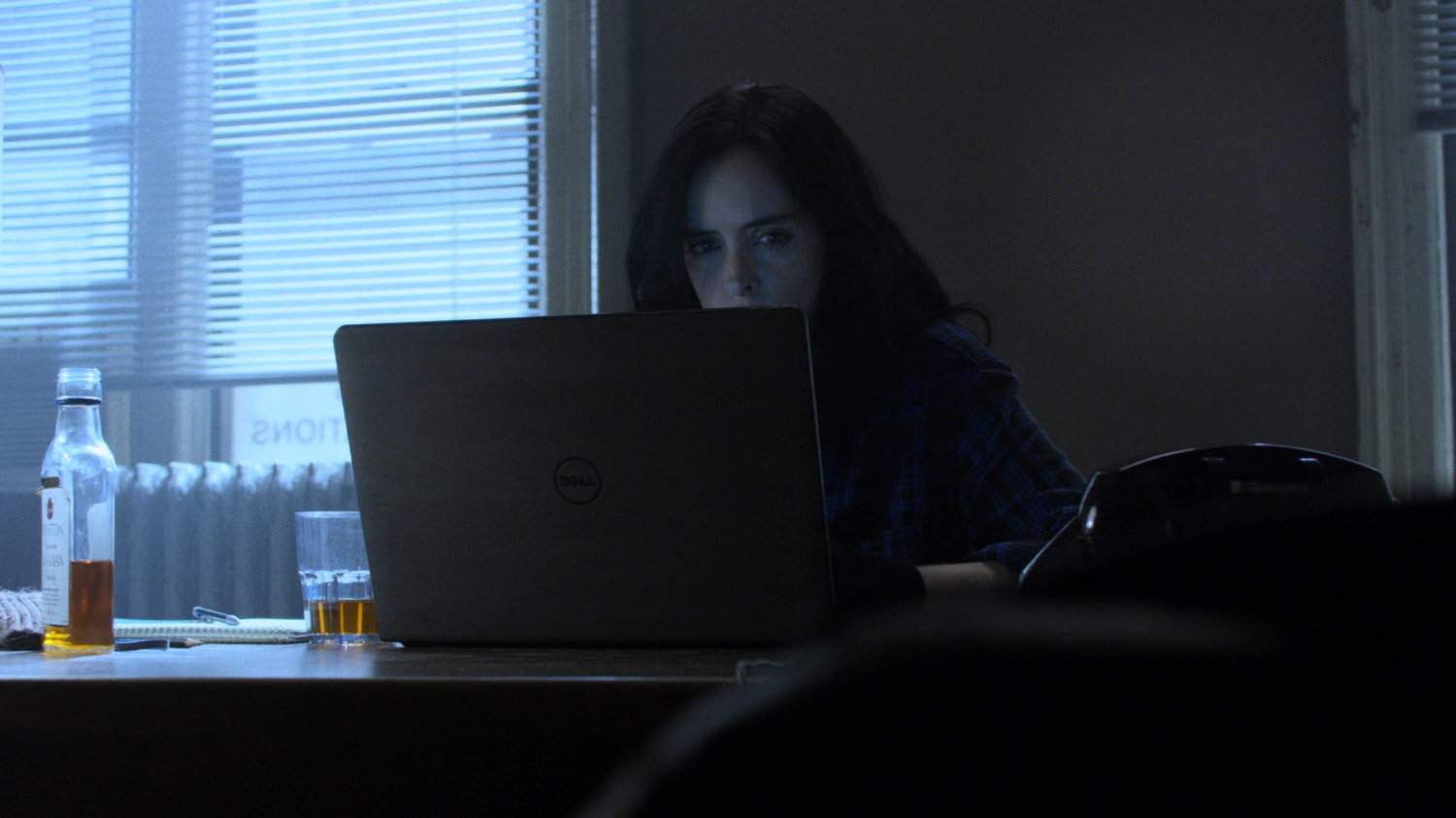 Jessica Jones on her computer in Alias Investigations office.