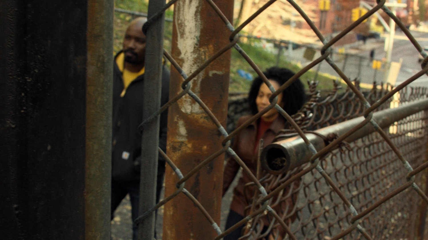 Luke and Misty walk along Harlem alley.