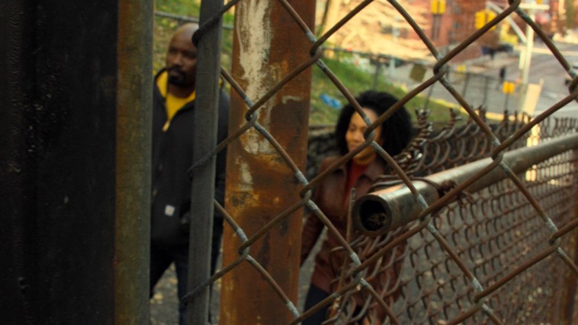 Luke and Misty walk along Harlem alley.